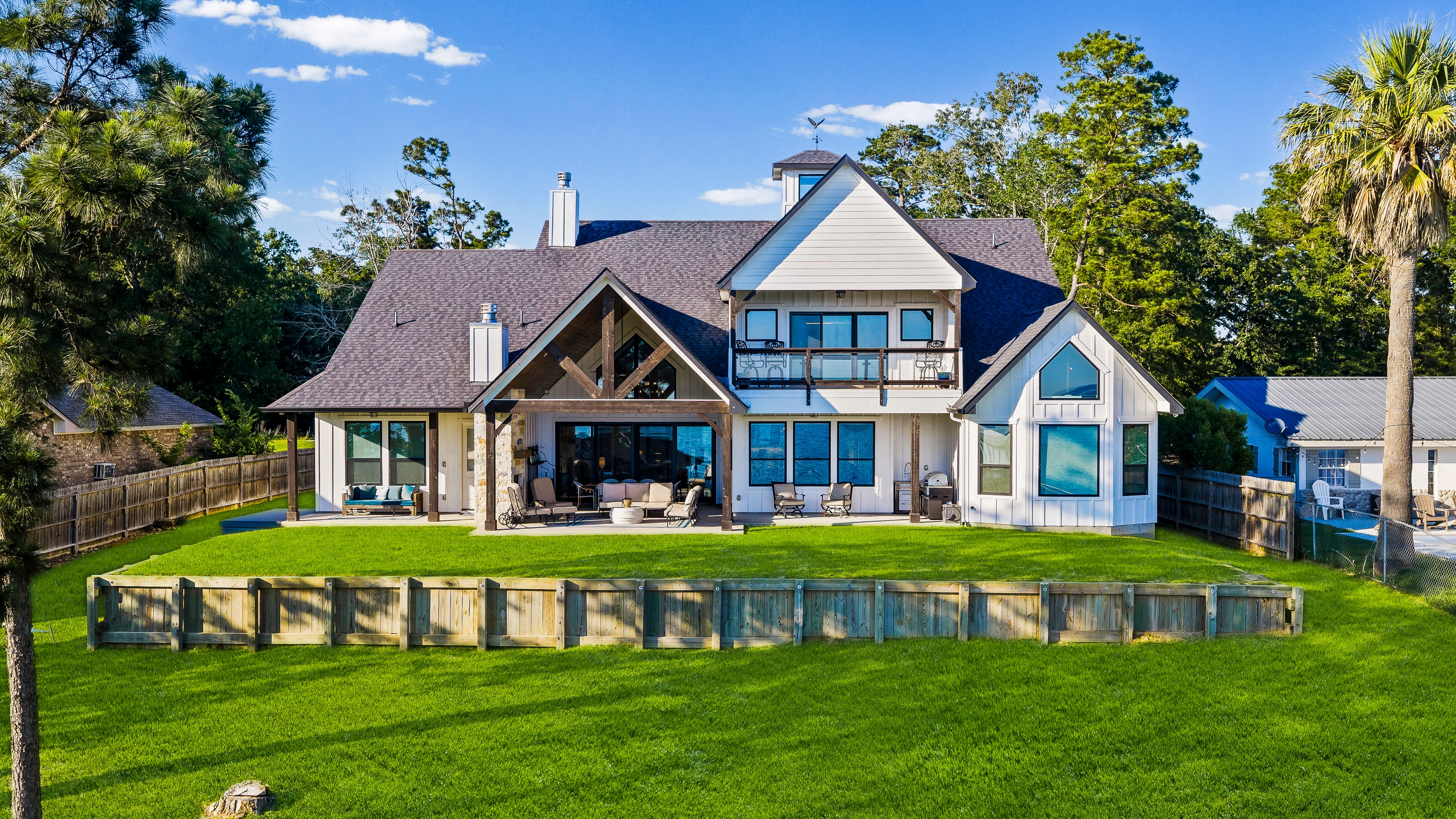 Modern waterfront home with manicured lawn