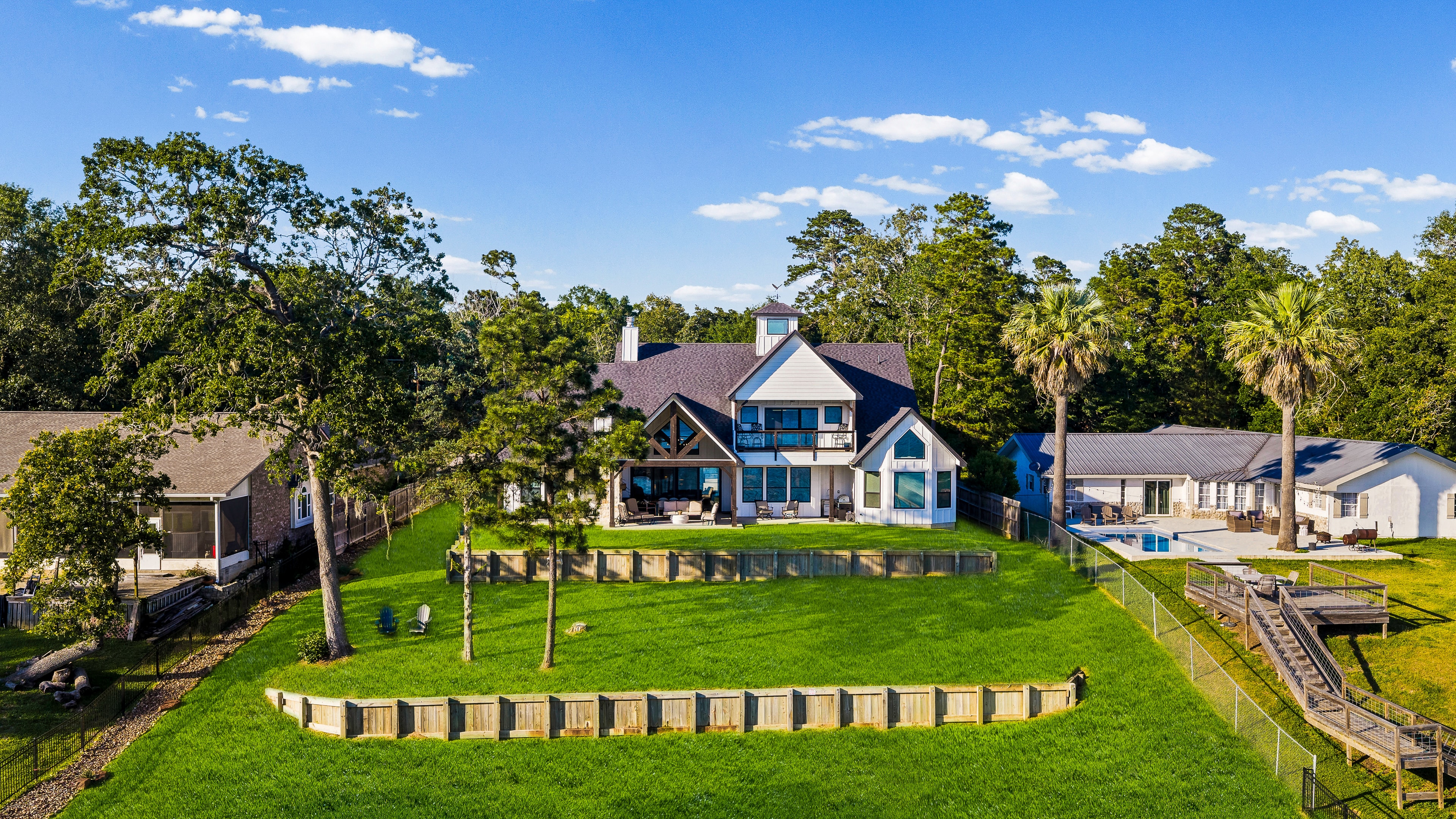 Lake house exterior with lawn and water views