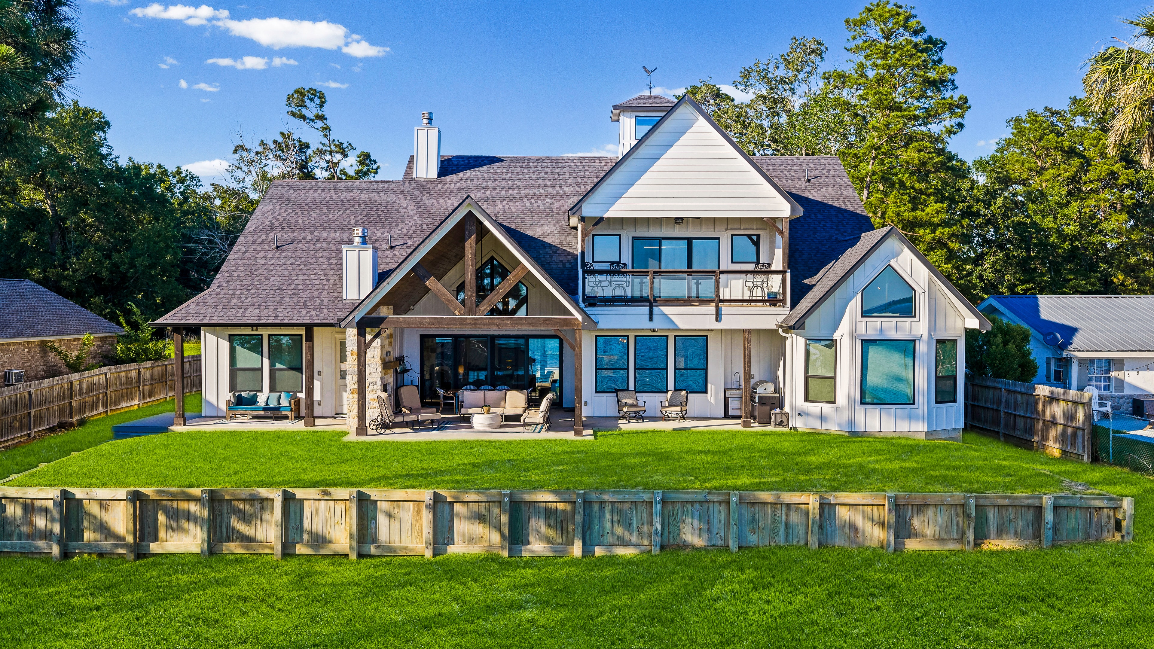 Modern farmhouse with waterfront lawn