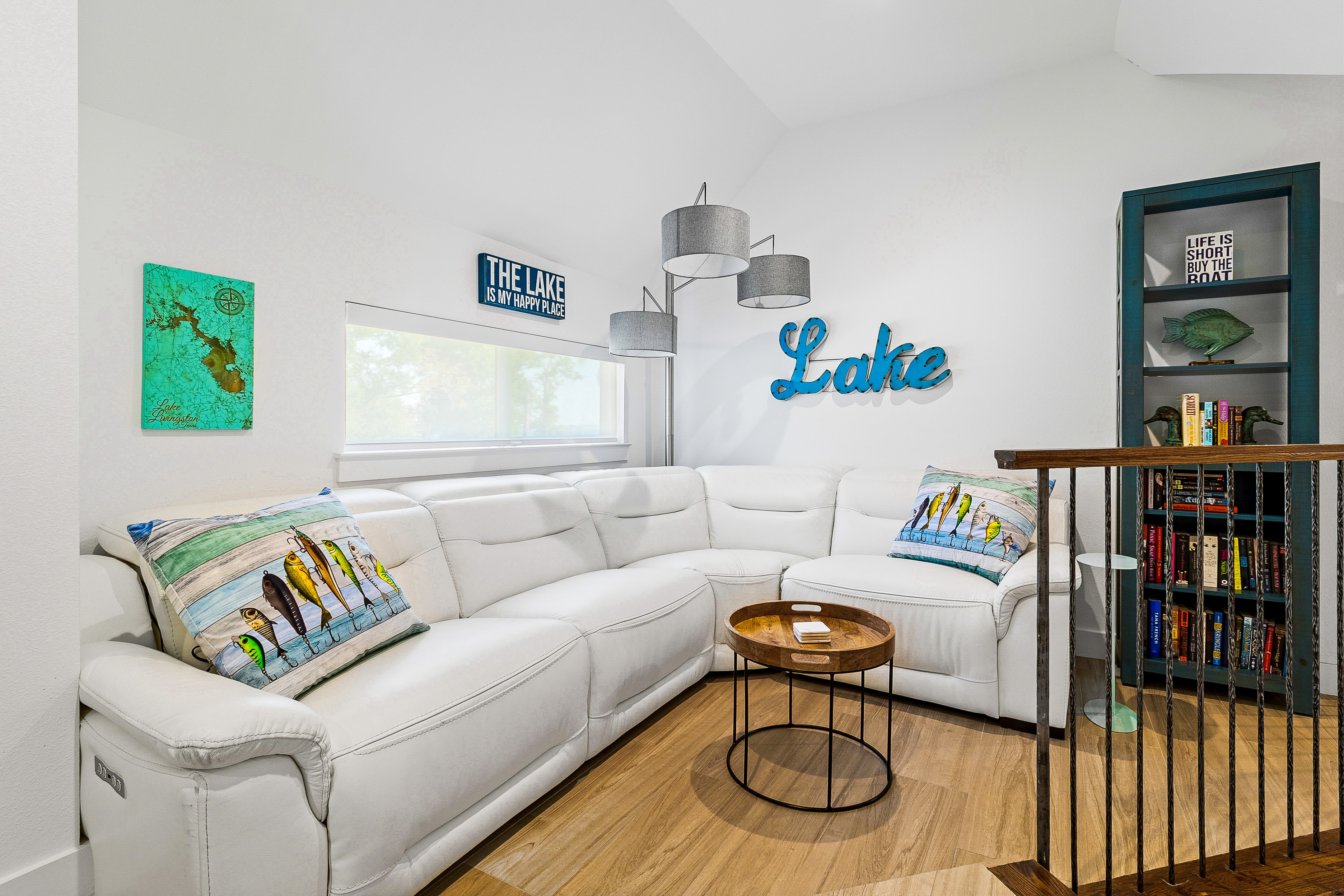 Lake-themed living room with white sectional sofa