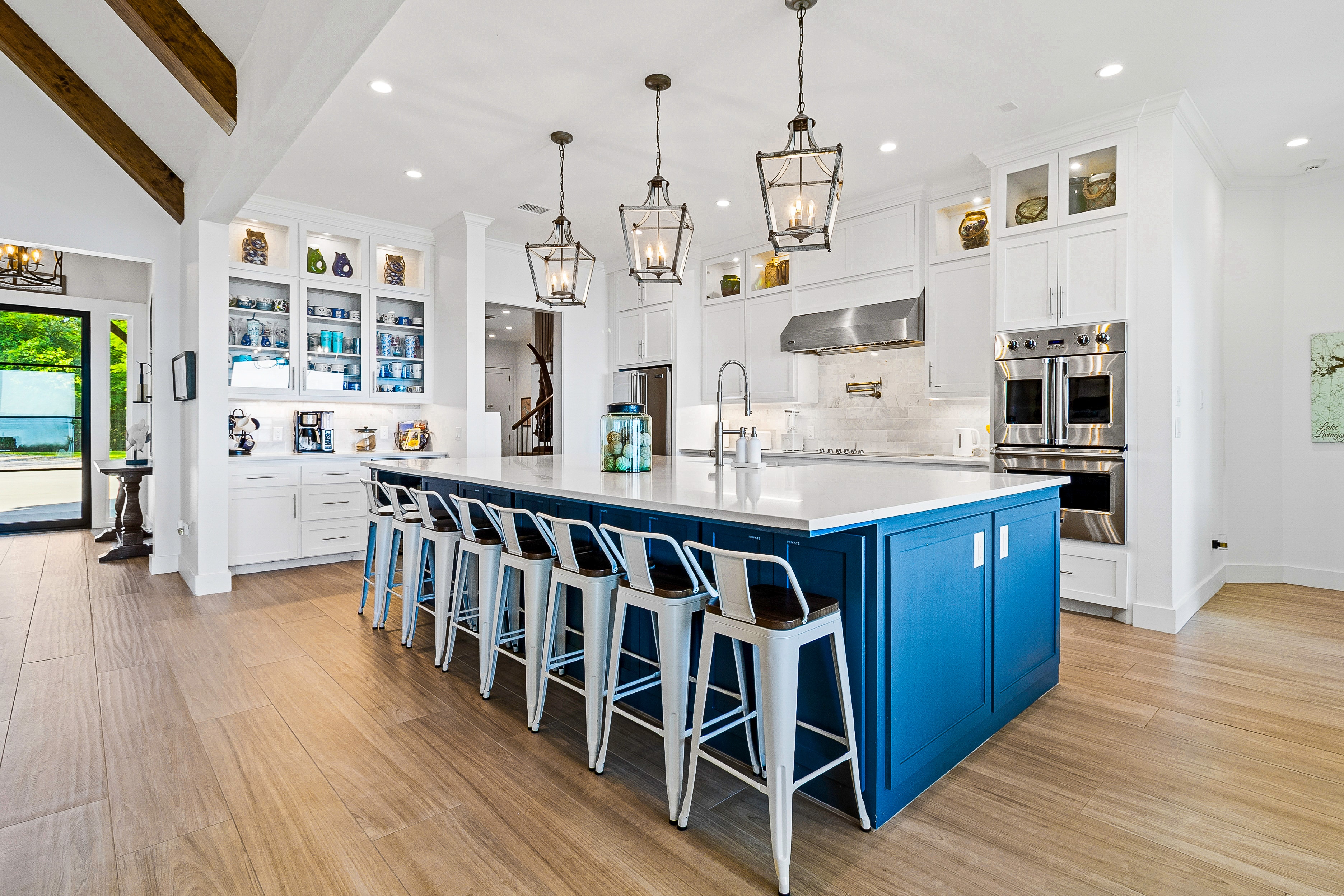 Modern kitchen with blue island and white cabinetry