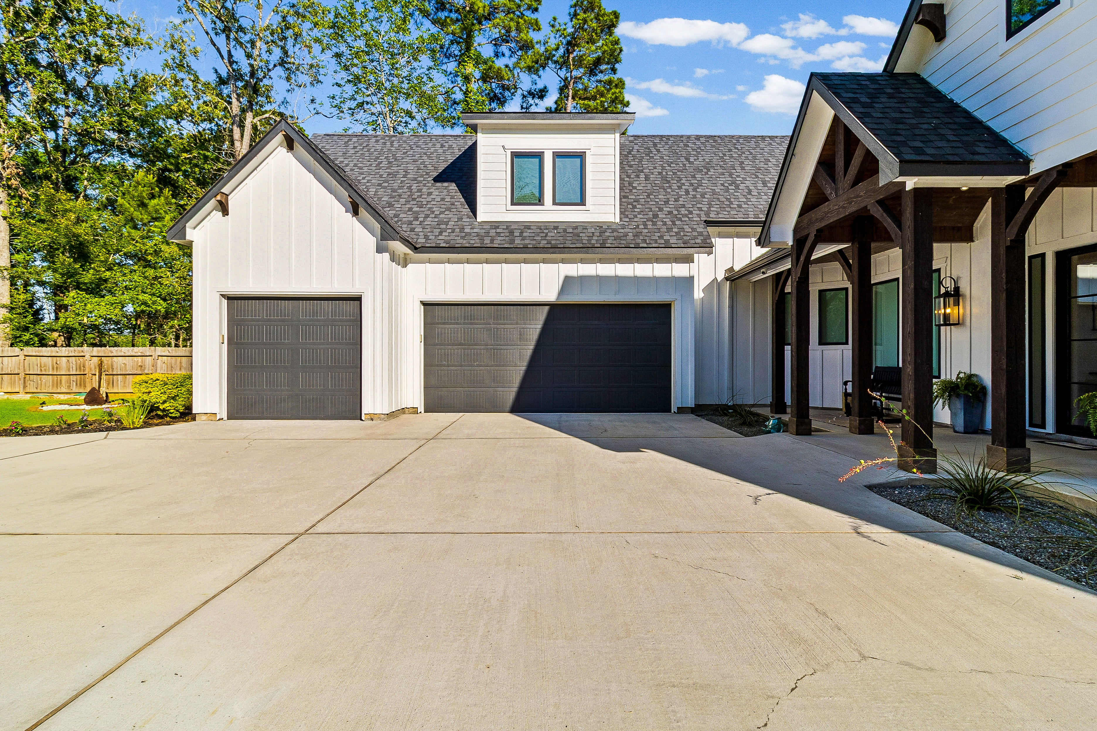 White farmhouse with garage and driveway