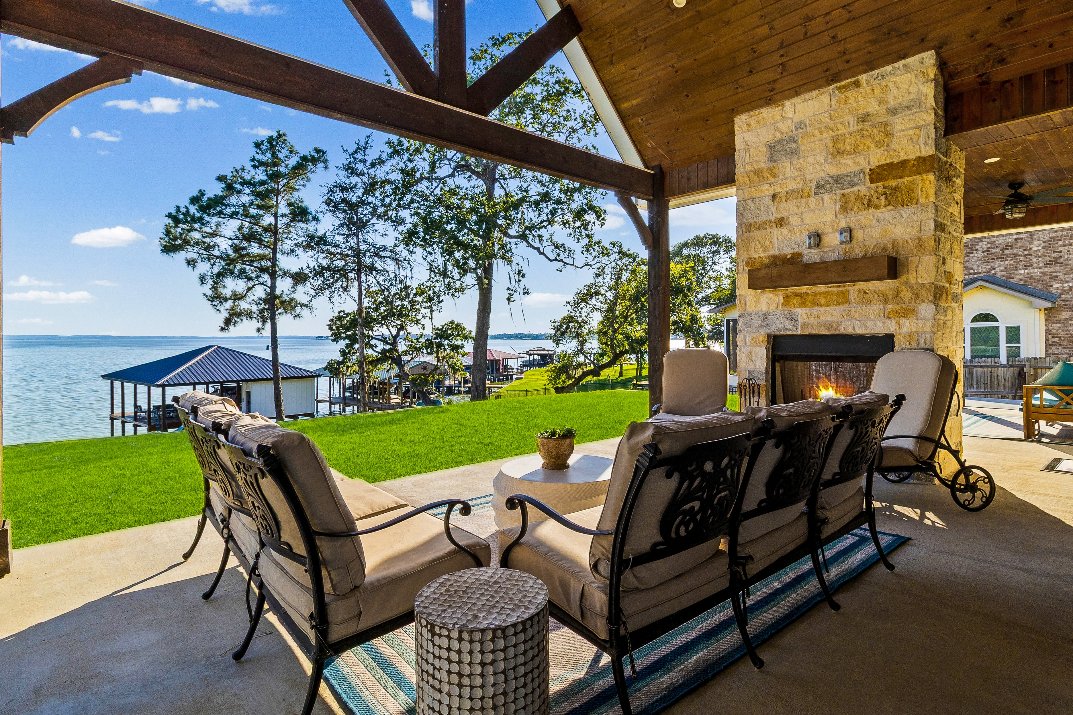 Lakefront patio with fireplace and seating