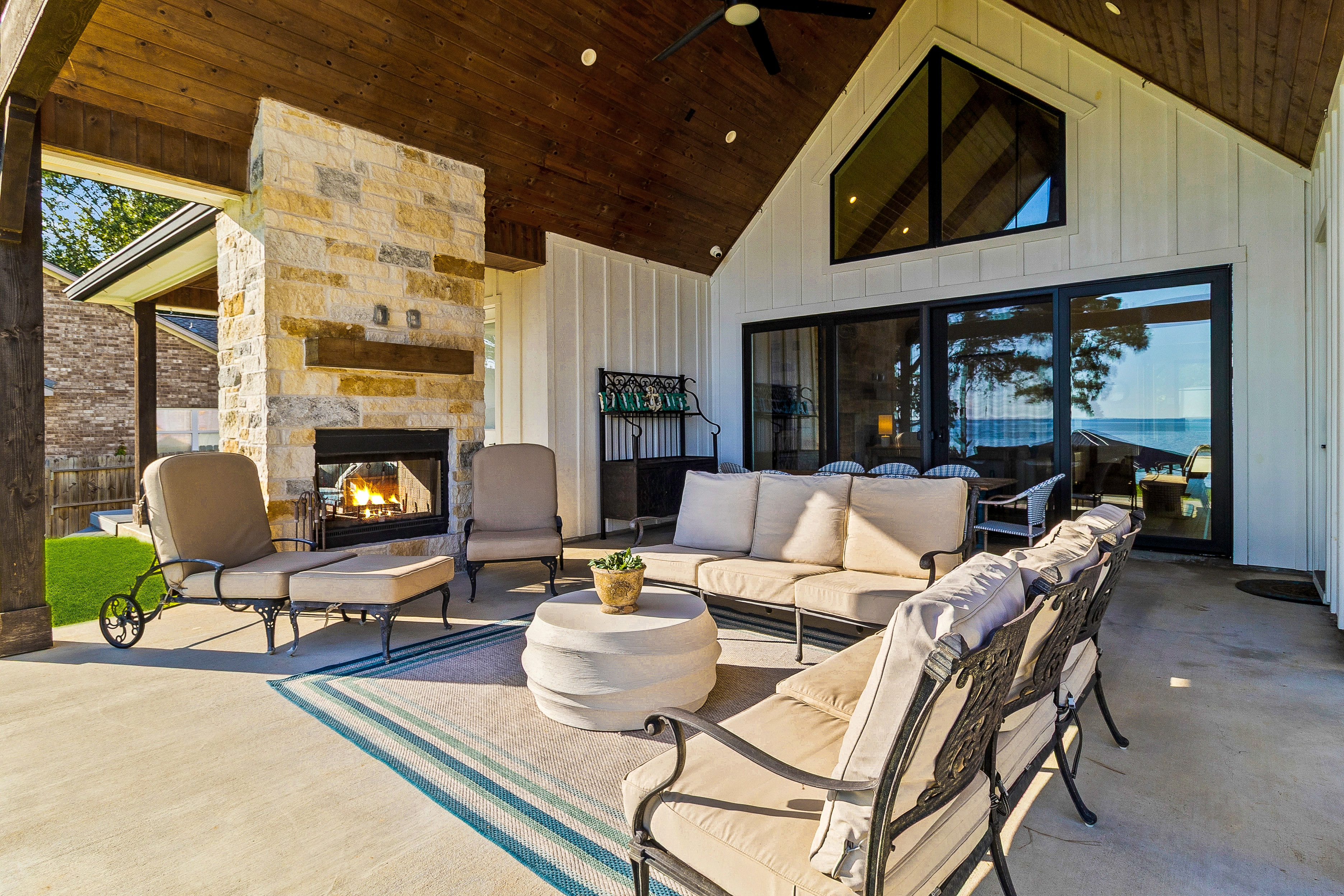 Modern patio with fireplace and lake view