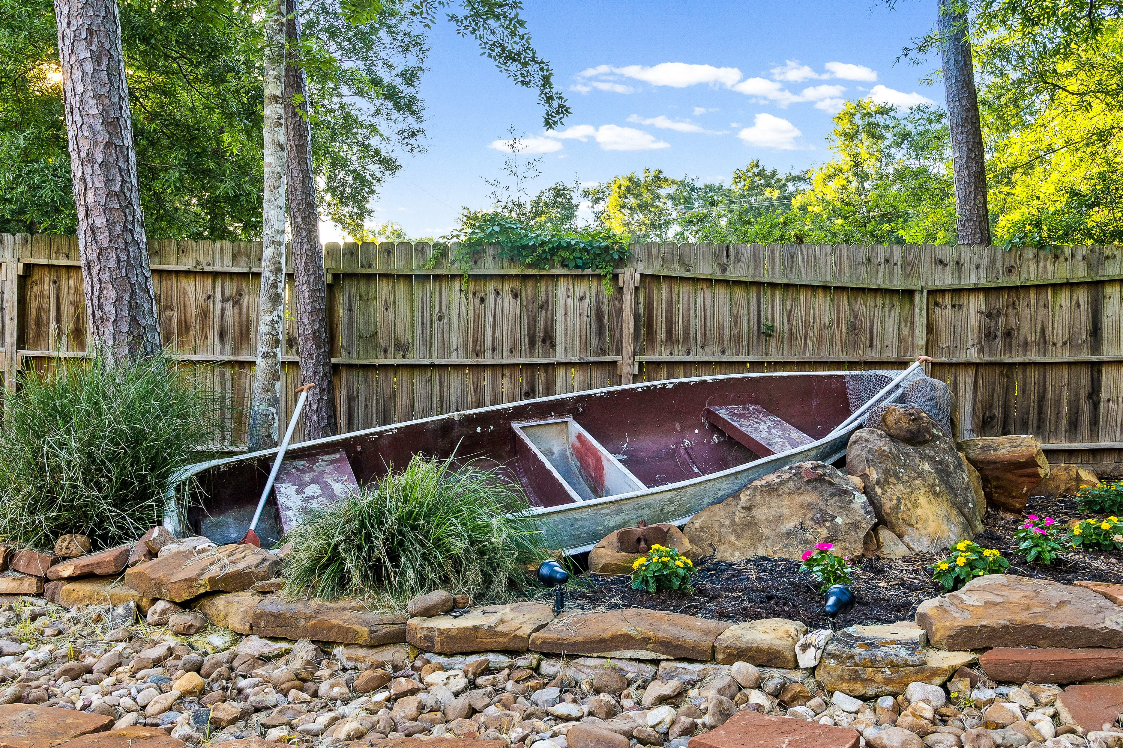 Weathered rowboat in backyard garden