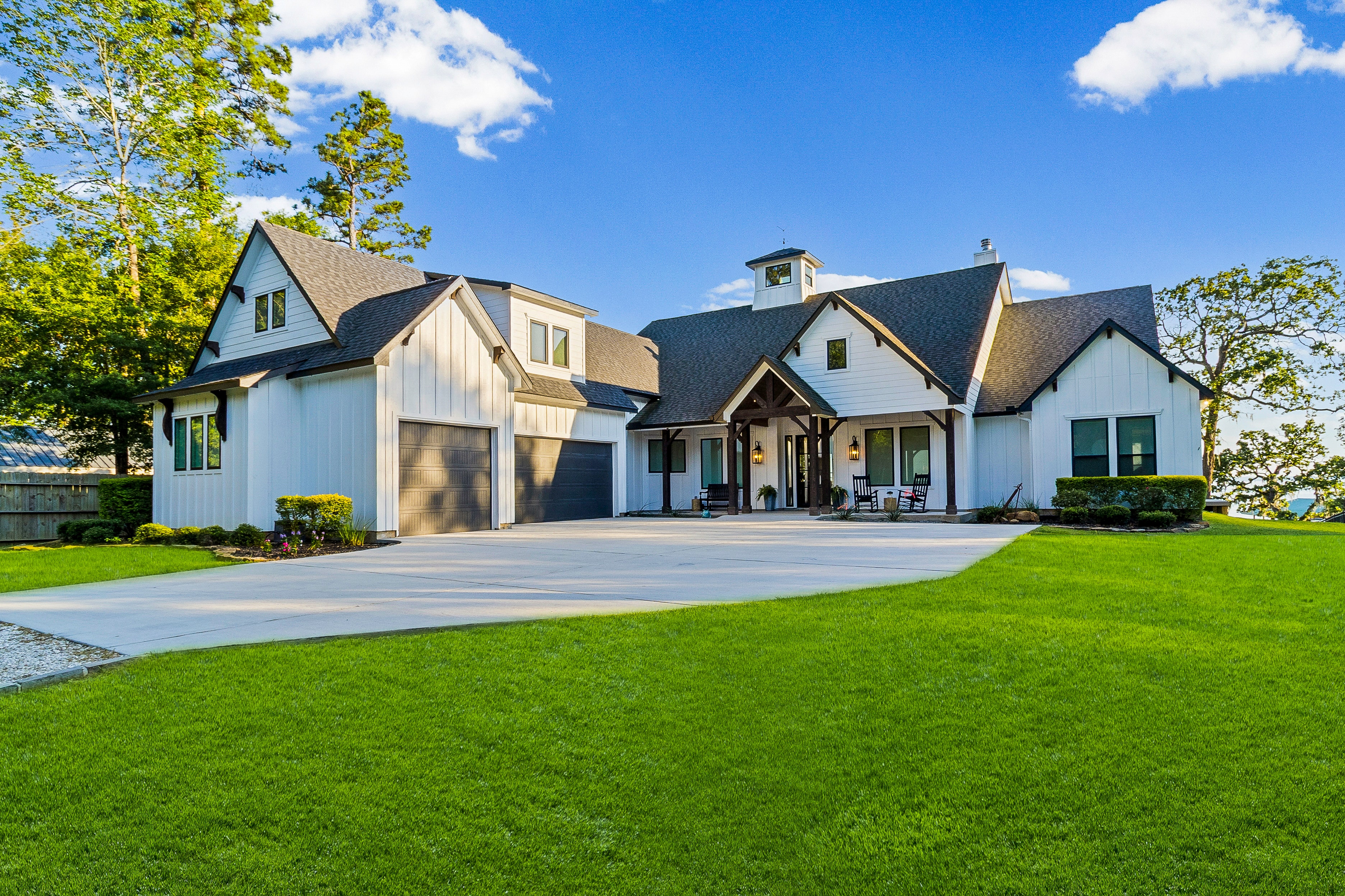 Modern white farmhouse with manicured lawn