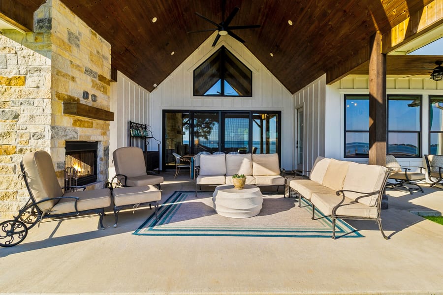 Outdoor deck with fireplace and lake views